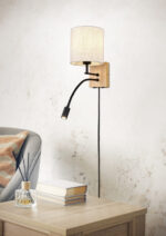 Armchair with table near light wall in room